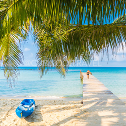 Pier with Small Blue Boat in Playa del Carmen, Mexico