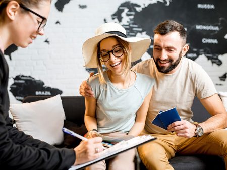 Travel expert discussing vacation options with a couple